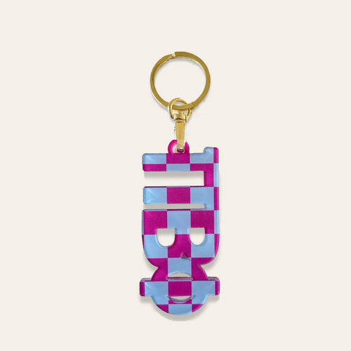 The Darling Effect’s Pi Beta Phi Acrylic Keychain features a gold ring and a flat, geometric pink and light blue checkered pendant, making it the perfect unique sorority gift.
