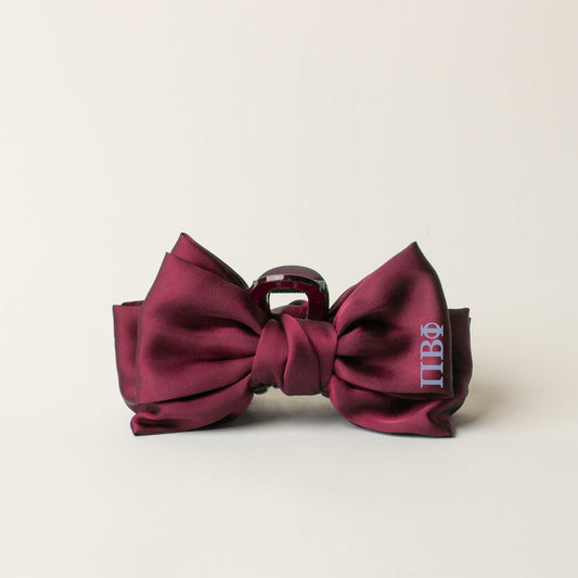 A burgundy satin bow tie with silver Greek letters embroidered on the right, perfect for pairing with The Darling Effect’s Pi Beta Phi Satin Bow Claw Clip, is shown against a plain light background.