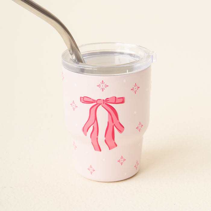 The Darling Effect Red Bow 2 oz Tiny Tumbler features a charming bow and flower pattern and comes with a silver straw.