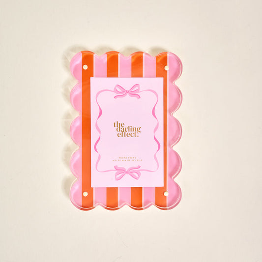 Showcase your photos in style with The Darling Effect Sicily Stripes Pink Rectangle Scalloped Acrylic Picture Frame, featuring chic pink and orange stripes and a clear scalloped design—perfect for modern décor lovers.
