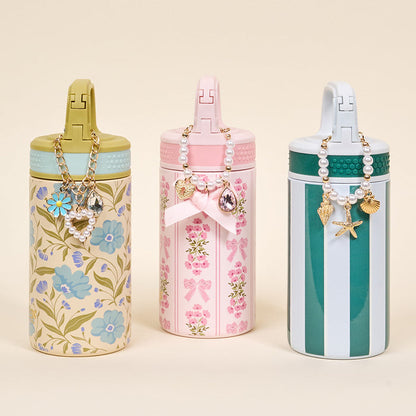 The Darling Effect's Sicily Stripes Teal 6 oz Lil' Bitty Bottle features chic green and white stripes and a beaded charm, making it a stylish, compact choice for staying hydrated on the go.