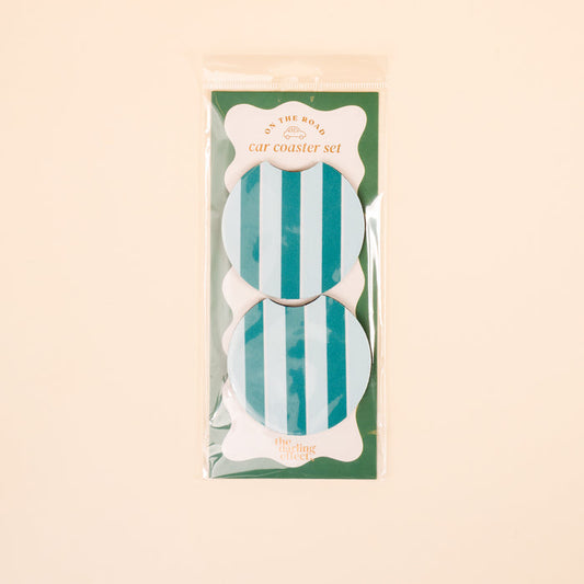 The Darling Effect Sicily Stripes Teal On the Road Car Coaster Set includes two round coasters with blue and turquoise stripes, shown on a light beige background—a stylish upgrade for your car accessories.