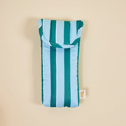 The Darling Effect's Sicily Stripes Teal Puffy Sunglasses Case features teal, light blue, and white stripes, a small bottom tag, quilted protection for eyeglasses, and a secure magnetic flap closure.