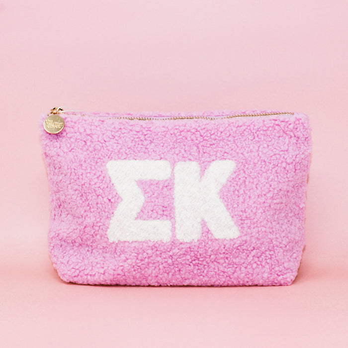 The Darling Effect's Sigma Kappa Lilac Teddy Letter Pouch is a soft, fleece-textured zip pouch with large white Greek letters on lilac—ideal as a cute sorority accessory for carrying essentials.