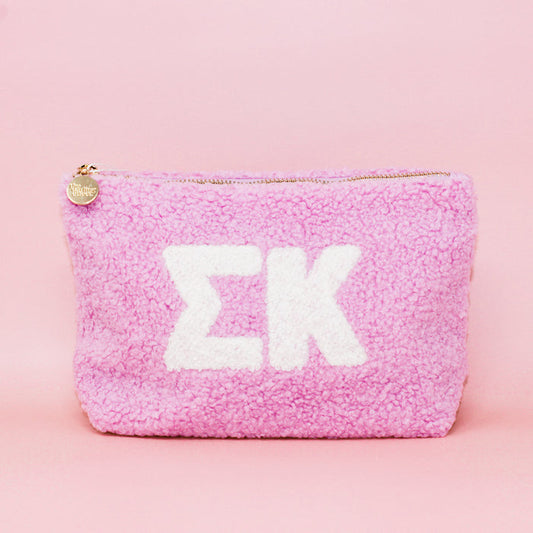 The Darling Effect's Sigma Kappa Lilac Teddy Letter Pouch is a soft, fleece-textured zip pouch with large white Greek letters on lilac—ideal as a cute sorority accessory for carrying essentials.