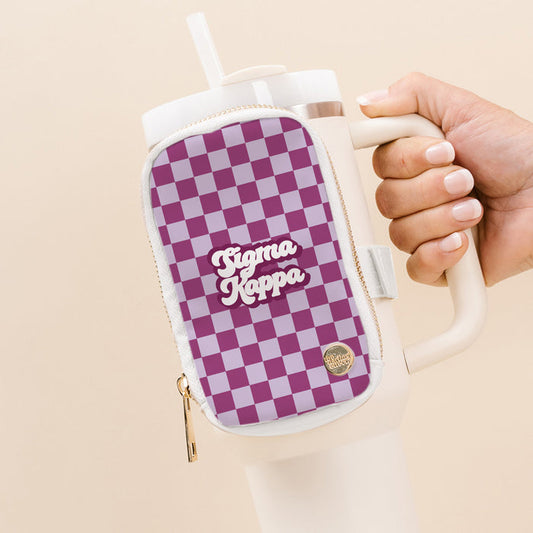 A hand holds a white tumbler with The Darling Effect’s Sigma Kappa Tumbler Fanny Pack—an attached purple and lavender checkered pouch with “Sigma Kappa” in white script—ideal for recruitment events.