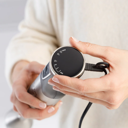 Handheld electronic device held by a person with a neutral background