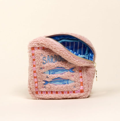 The Darling Effect Square Sardines Teddy Pouch features pink sherpa fabric, sardine and SARDINES embroidery, a blue striped interior—perfect to add to your teddy pouches accessory set.