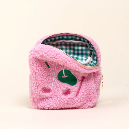 The Darling Effect's Square The Golf Edit Teddy Pouch features pink sherpa fabric, embroidered golf clubs and a green patch, plus a green and white checkered lining—ideal for stylish, on-the-go organization.