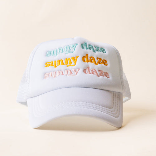 The Sunny Daze Trucker Hat by the-darling-effect features "sunny daze" embroidered three times in pastel green, yellow, and pink on an off-white background—making it a must-have trendy accessory this season.