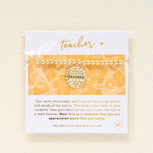 The Darling Effect’s Teacher Beaded Charm Bracelet features a “Teacher” sentiment charm and comes on a yellow and white floral card with a message of appreciation, making it a thoughtful gift.