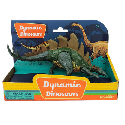 The Toysmith 7in Dynamic Dinosaurs features a green stegosaurus with brown plates and movable limbs in an open box with dino illustrations, branding, and a small parts warning.