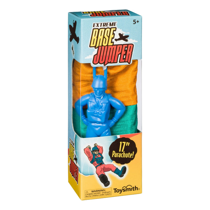 The Toysmith Base Jumper features a blue parachute man with a no-tangle orange and green parachute, designed for ages 5+. Perfect for outdoor play, its box displays fun artwork and key product info.