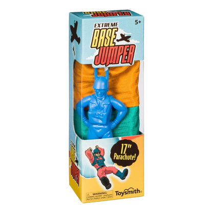 The Toysmith Base Jumper features a blue parachute man with a no-tangle orange and green parachute, designed for ages 5+. Perfect for outdoor play, its box displays fun artwork and key product info.