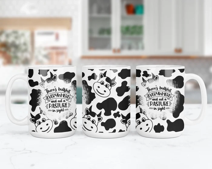 Wraparound view of Udderly Over the Bullshit funny cow mug with black-and-white cow spots and sarcastic adult-humor saying.