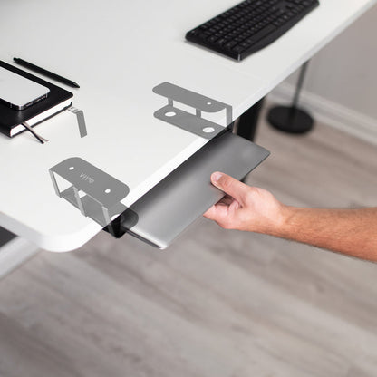 Easy access to the laptop while stored underneath the desktop.