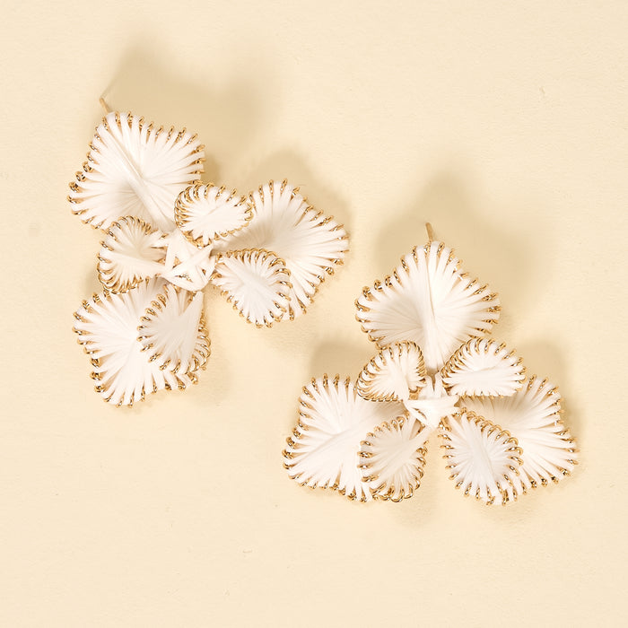 The Darling Effect’s White Main Character Earrings are statement boho florals with white petals and gold edges, displayed on a beige background—lightweight and perfect for everyday wear.