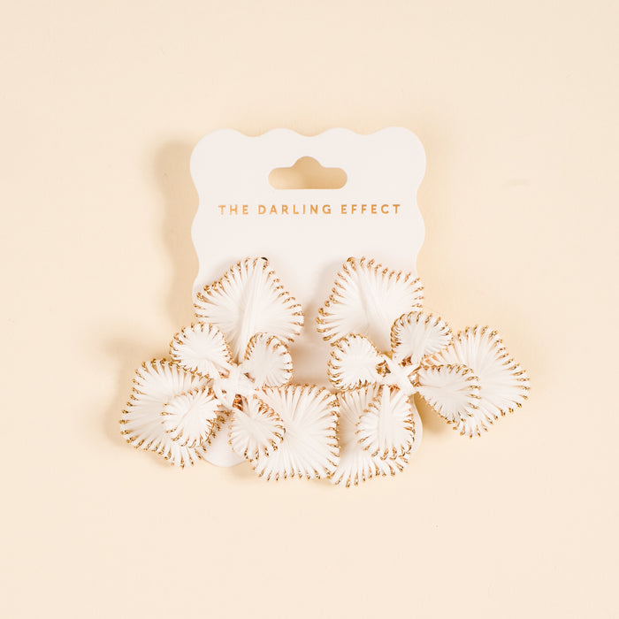 White Main Character Earrings by The Darling Effect: petal-shaped white earrings with gold trim on a light peach background, lightweight for everyday wear, displayed on a card reading THE DARLING EFFECT.