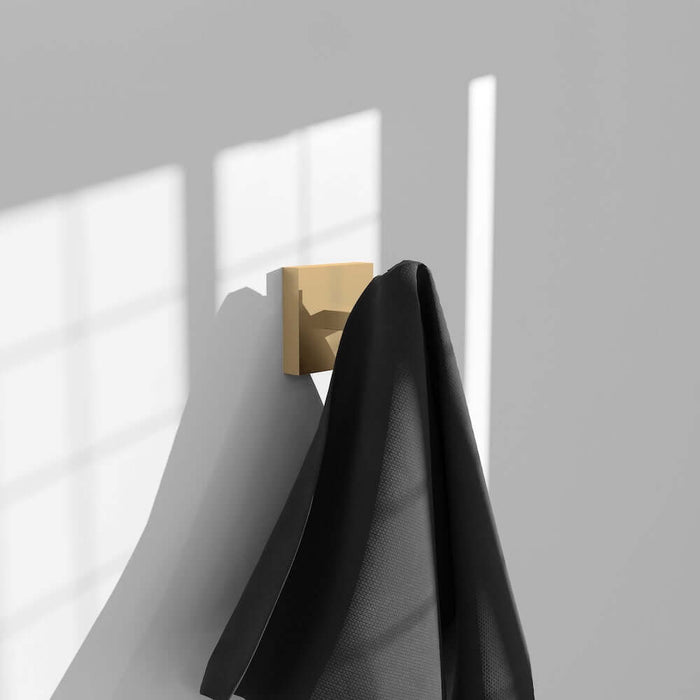 ZLINE Palisades Towel Hook in Champagne Bronze (RBCN1-HK-CB) with a black towel on a gray wall